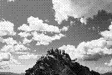 Dithered photograph of cumulus clouds over a dark hill