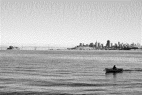 Dithered photograph of a calm sea meeting a distant city