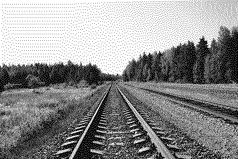 Dithered photograph of railway tracks running to the horizon